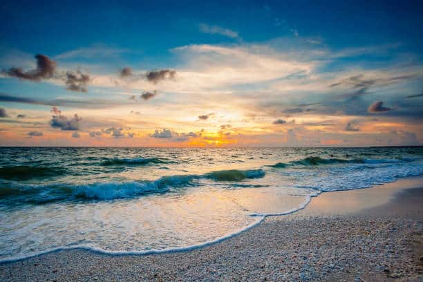 Marco Island in Florida has beautiful sunsets. The waters of the Gulf of Mexico roll in over seashells deposited on the beach.
